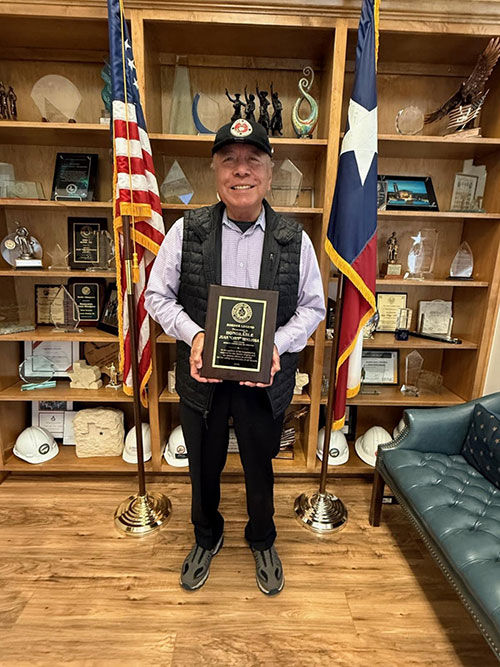 Photo: Sen. Hinjosa poses in his office holding his BPU “Border Legend Award”